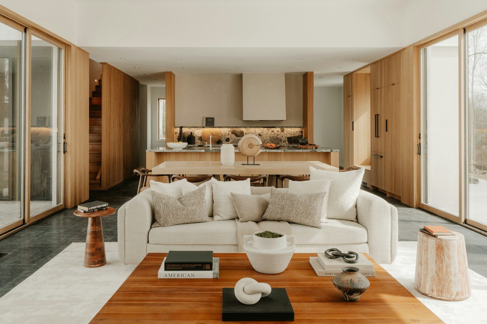Modern living room and kitchen with natural wood accents.